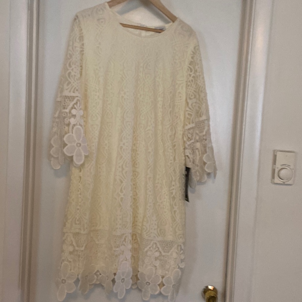Beautiful ivory cream lace sheath dress, knee length with polyester lining.